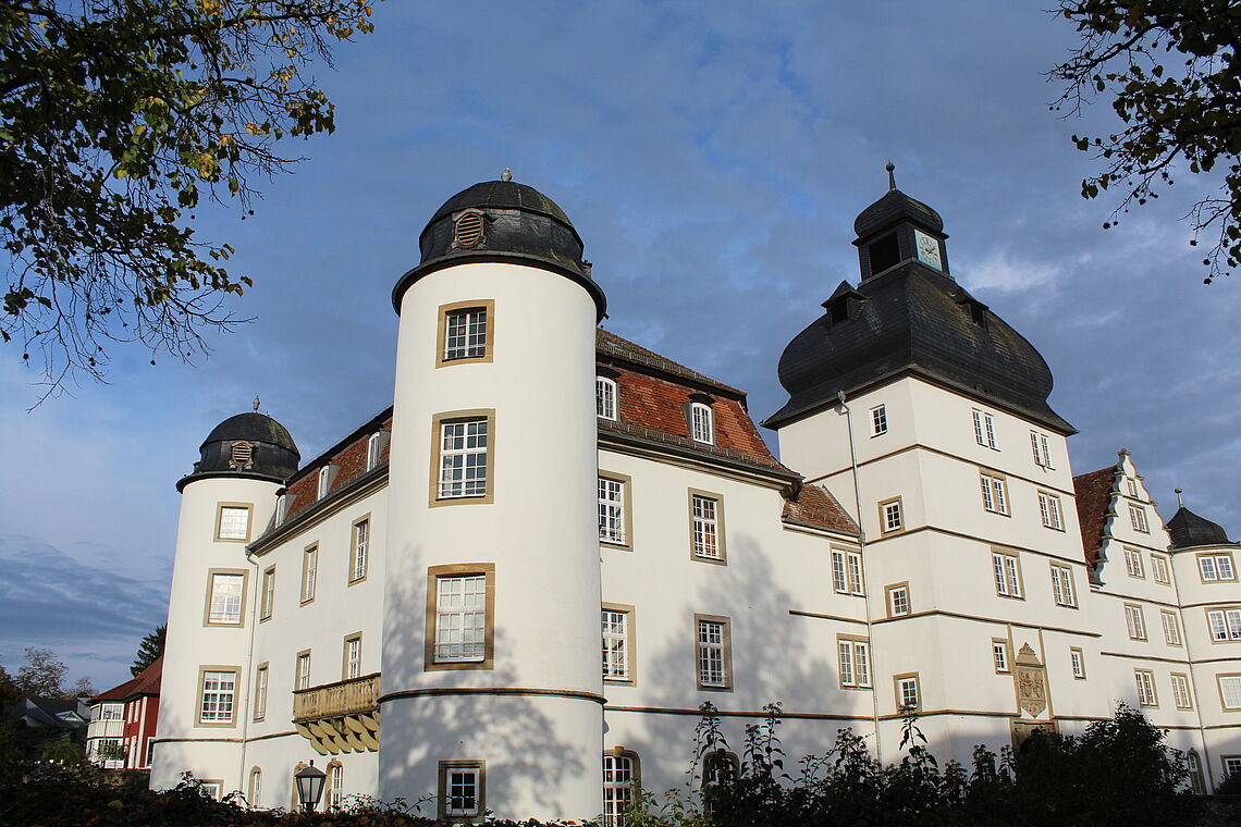 Das Schloss Pfedelbach ist zu sehen. Es hat eine weiße Fassade.